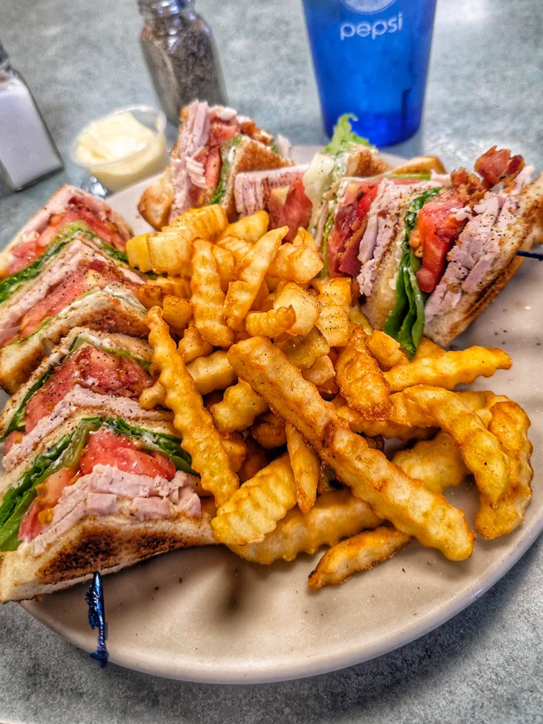 Turkey club sandwich with fries at Golden Bear Restaurant in Largo, Florida